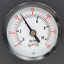 Round analog pressure gauge showing system pressure
